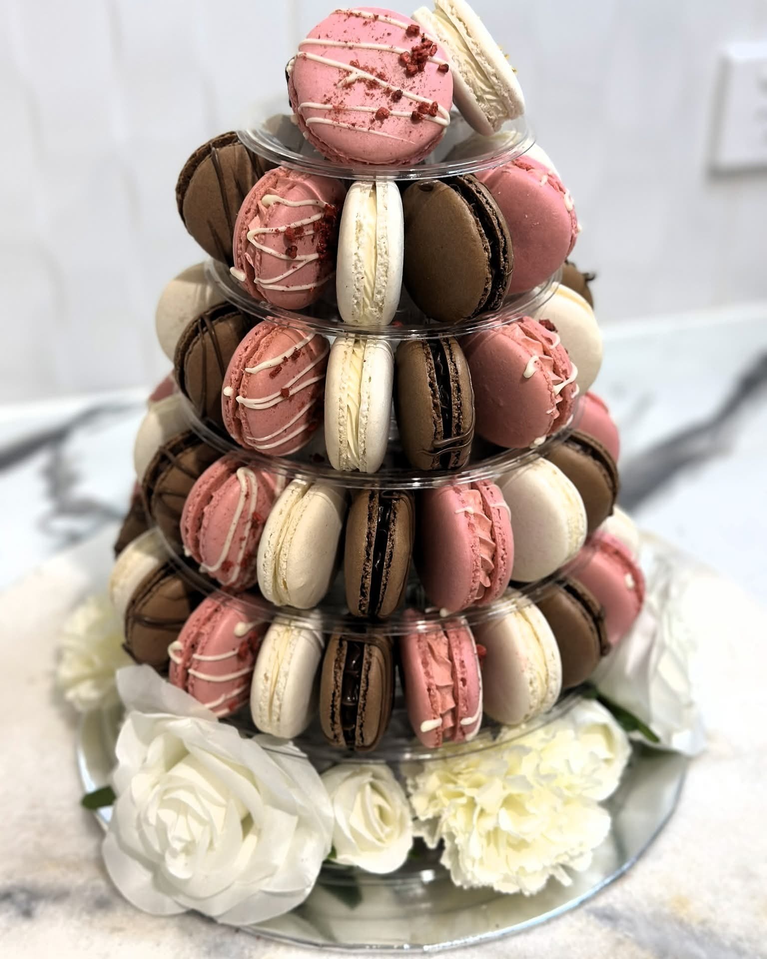 Whitsunday Sweet Delights — macaron tower with white roses for celebrations Airlie Beach